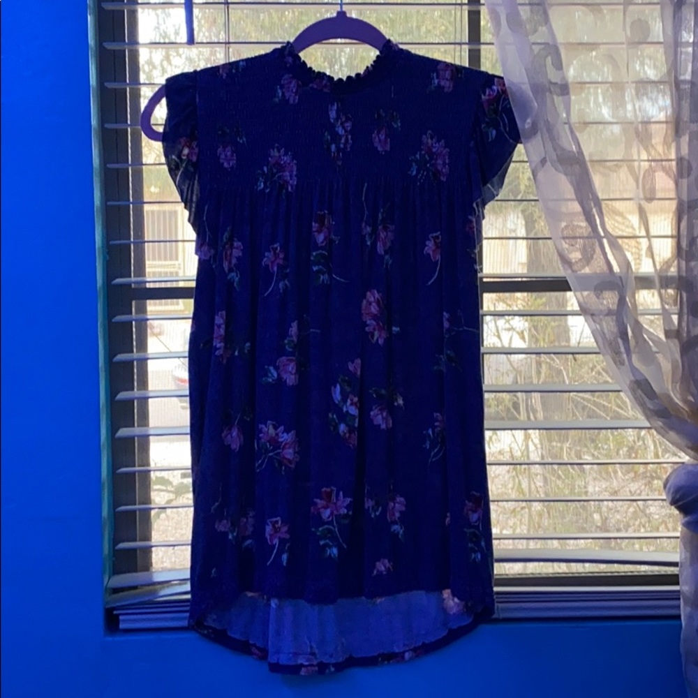 Blue shirt with flowers on it